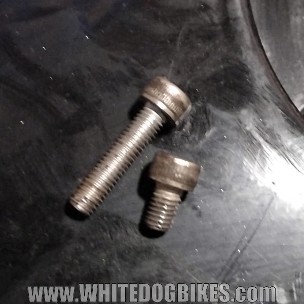 The 2 different sizes of bolts used to secure the outer ring of the filler cap