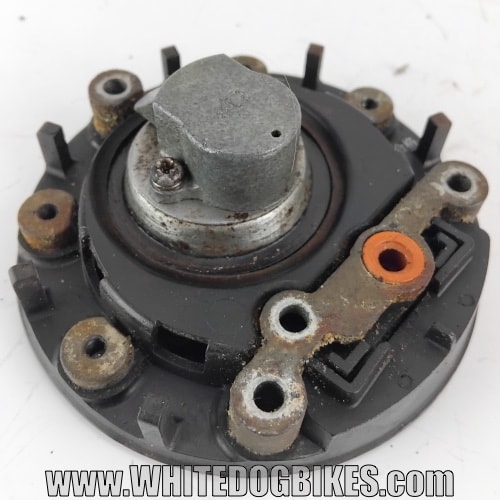 Bottom view of a filler cap showing the security bolt hole and venting