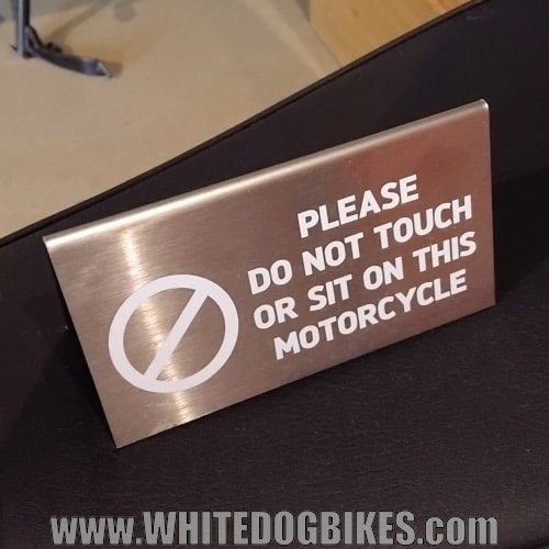 Do not sit on the bikes sign