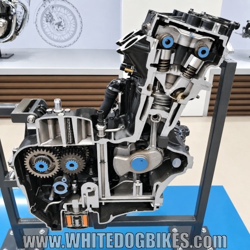 A Triumph engine cut in half showing the internals including the pistons, crankshaft, cam shafts and valves