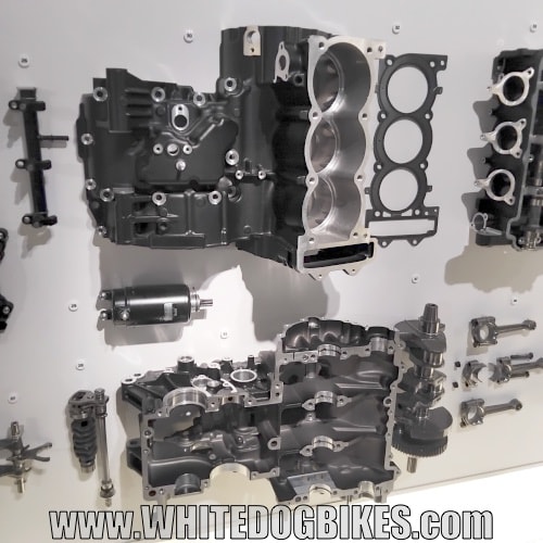 The crankcase from a bike in bits on the wall as you come in