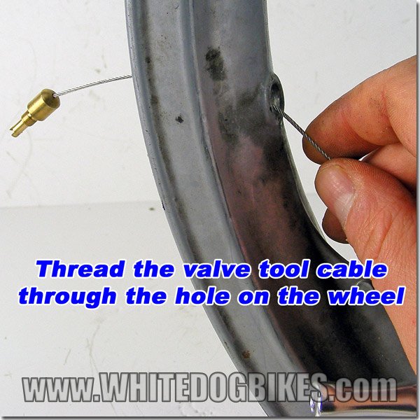 Thread the valve tool head through the hole