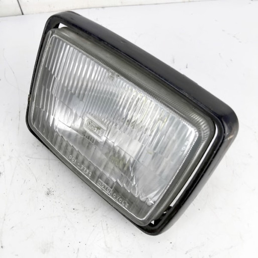 OEM Kawasaki GT550 (Z550GT) used headlight in black with light surface rust on the case
